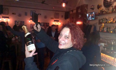 Claudia Masueger sabering a bottle of bubbly at XL New Year’s Eve Beijing China